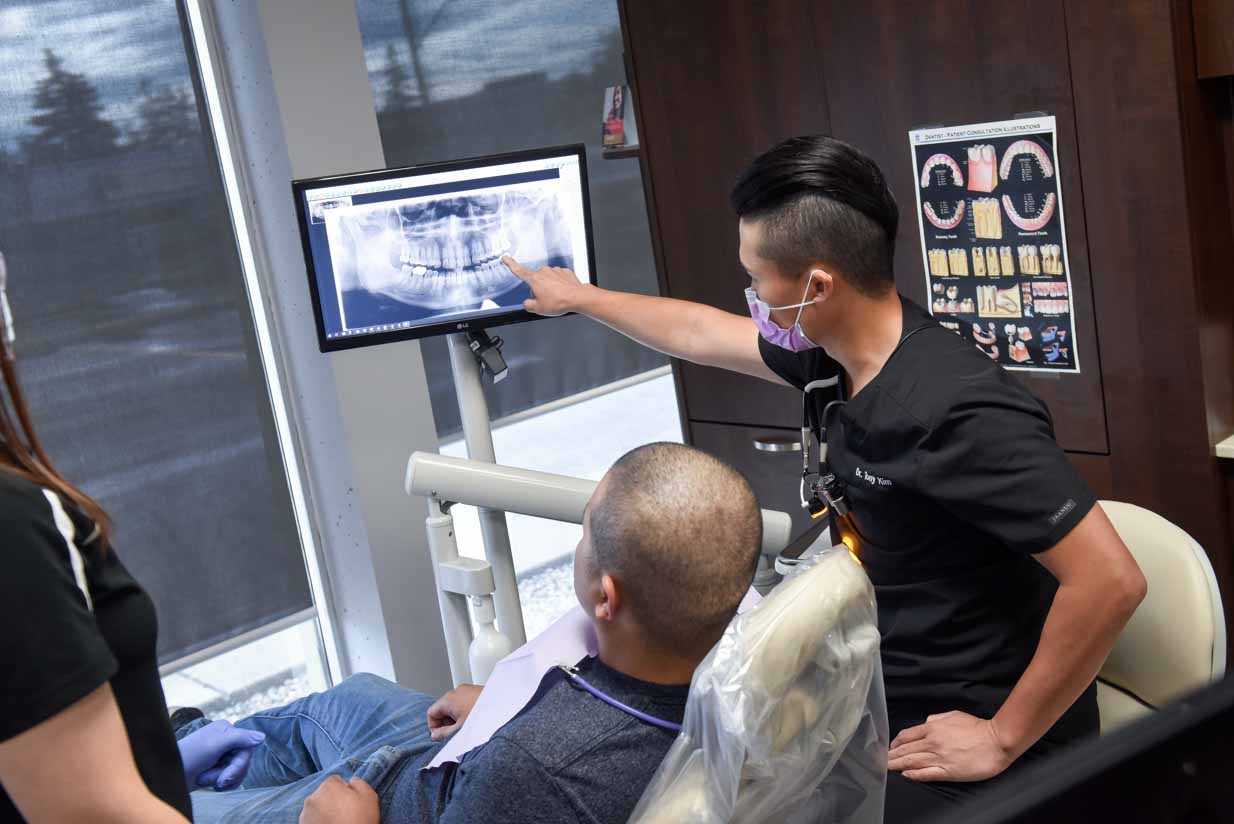 Dr. Tony Kim Discussing Diagnosis with Patient | NE Calgary Dentists | Pathways Dental Clinic | Calgary Emergency Dental Care